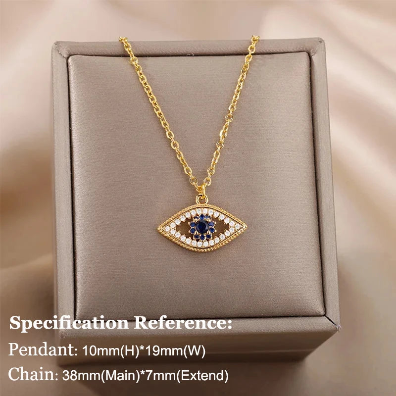 Gold necklace with an eye-shaped pendant on a beige box