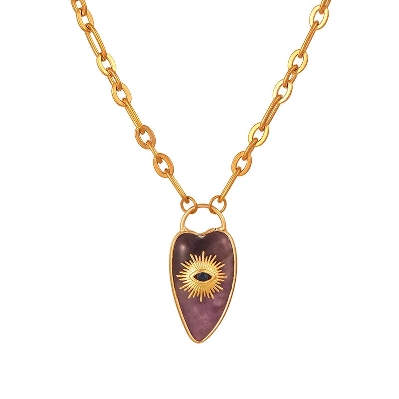 Gold necklace with a heart-shaped pendant on a white background