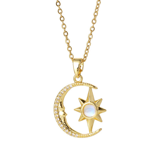 Gold necklace with moon and star pendant on a white background