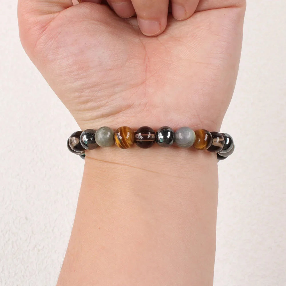 Beaded bracelet on a wrist against a plain background